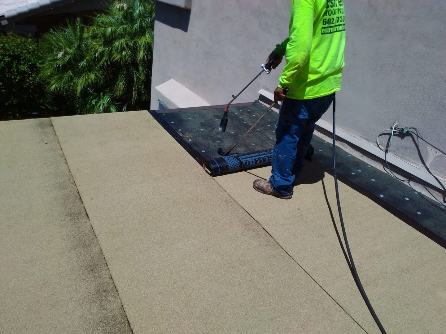 A person installing the Flat roofs on the house